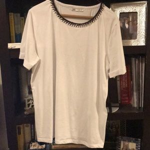 Super cute white shirt with neck detailing.